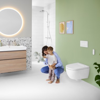 Жінка з дитиною у яскравій ванній кімнаті з дзеркалом Geberit Option